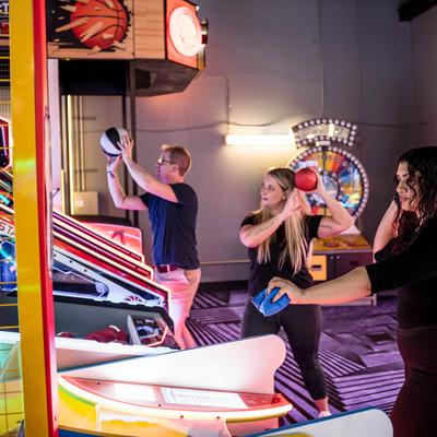 Playing arcade basketball.