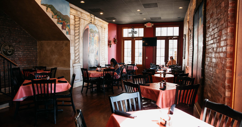 Interior, dining area with two guests sitting at tables