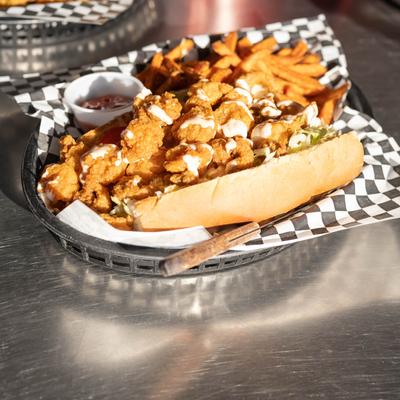 Deep fried meat sandwich, sauce dip and fries.