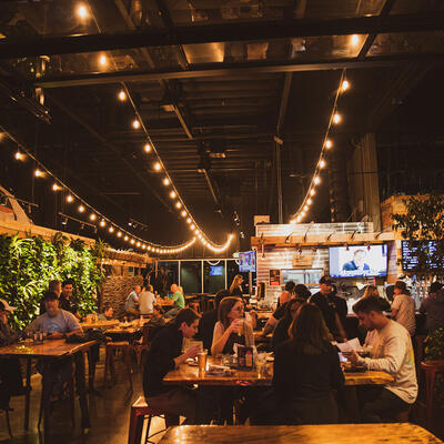 Cozy pub  scene with people enjoying drinks at tables.