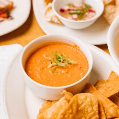 A chili cheese dip, served with tortilla chips.