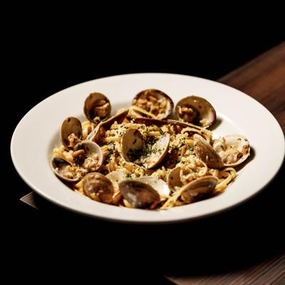 Linguini alle Vongole topped with grated cheese and herbs.