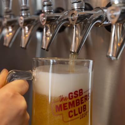 Beer being poured from a tap into a glass mug.