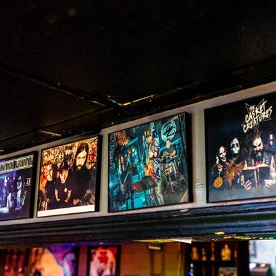 Posters of various bands on the wall.