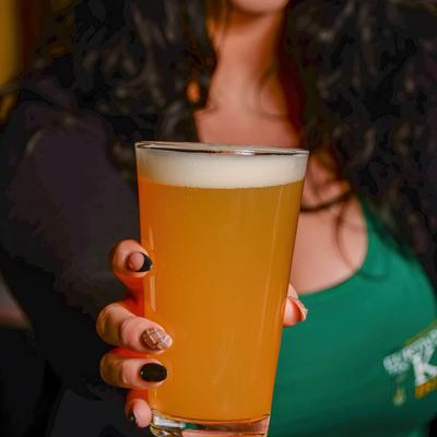 Bartender holding a glass of beer
