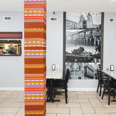 Restaurant featuring a support column wrapped in a vibrant striped textile.