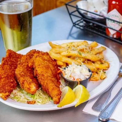 Cod fish and chips served with coleslaw and beer.