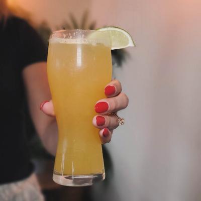 A hand holding a drink.