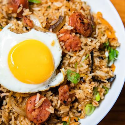 Fried rice, with sausage and topped with egg.