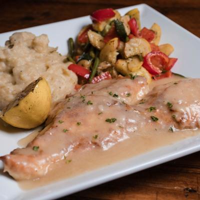 Chicken Francaise served with mashed potatoes, sauteed veggies and half of lemon.