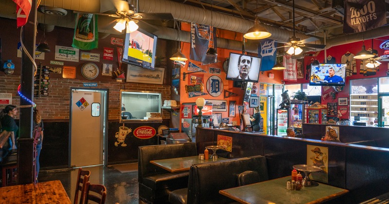 Interior, dining booths, hanging TVs,  various wall decorations