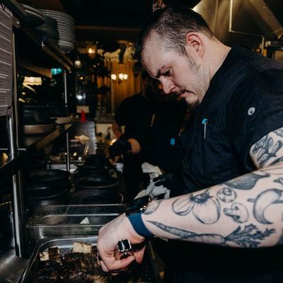 Kitchen staff cutting meat.