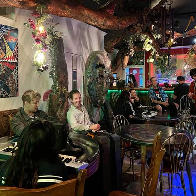 Lots of people at the venue, sitting at their tables.