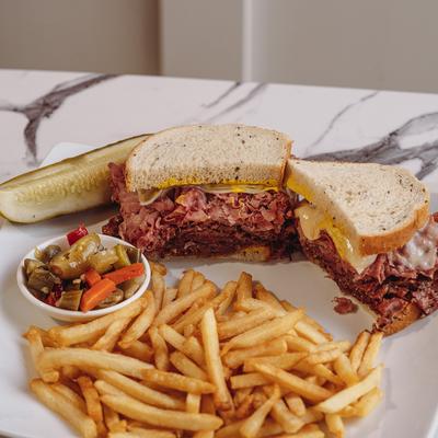 Sandwiches, fries, and a salad on the side.