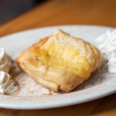 Baklava served with whipped cream and honey