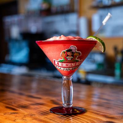 Frozen Strawberry  Margarita on a bar counter.