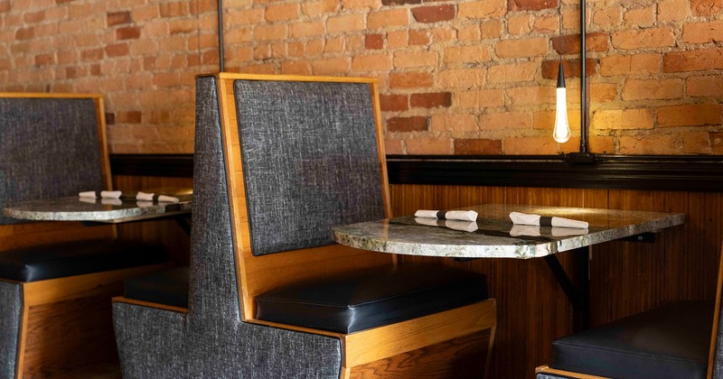 Interior, dining booth with table set for two guests