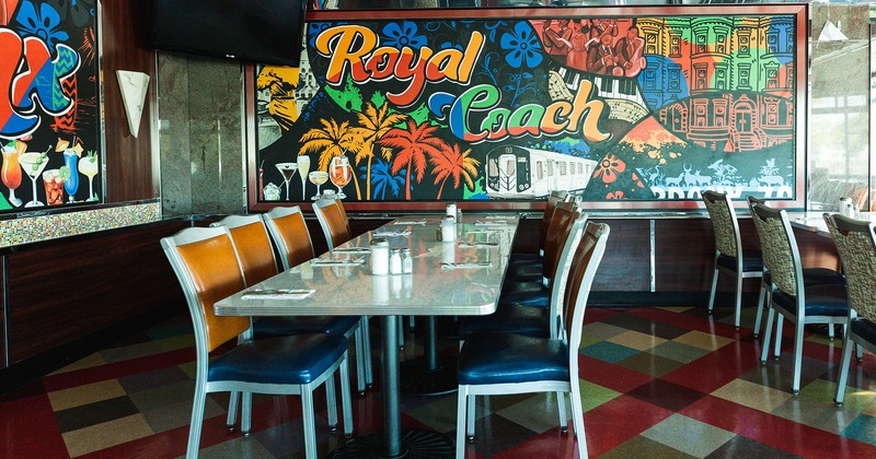 Interior, dining tables in an area with mural art