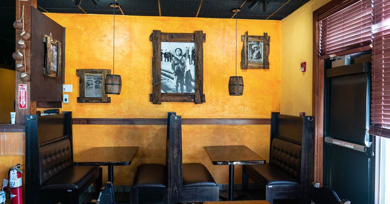 Restaurant booths by a wall with vintage photos