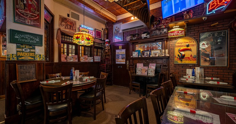 Interior featuring a stained glass lamp and a brick wall decorated with vintage posters