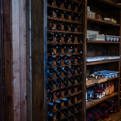 Custom-made rustic wooden wine storage unit with a dark finish.