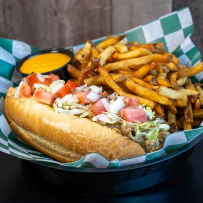 Cheesesteak Hoagie paired with fries and cheese dipping sauce.