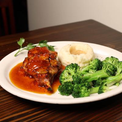 Pork Chop with apricot glaze  with mashed potatoes and broccoli.