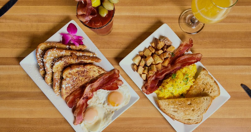 Two different breakfast plates and drinks, overhead view