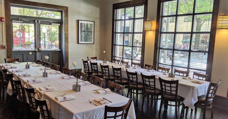 Interior, two long tables set for guests