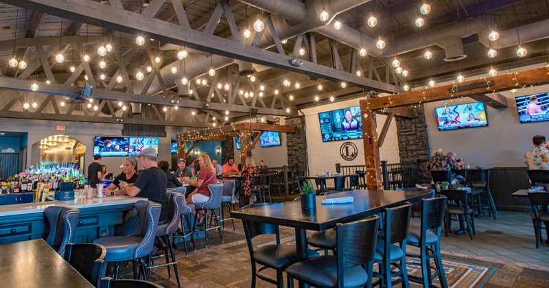 Seating area with people sitting at the bar in the back