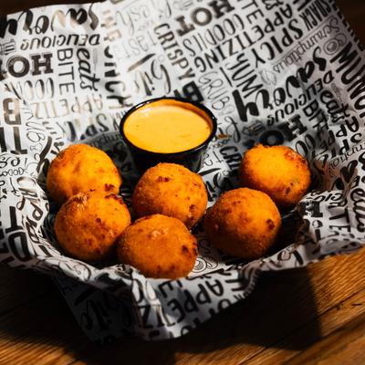 Fried cheese balls, with jalapenos, bacon, and dip.