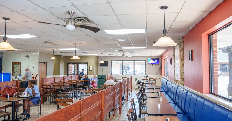 Interior, seating area with few customers in the back