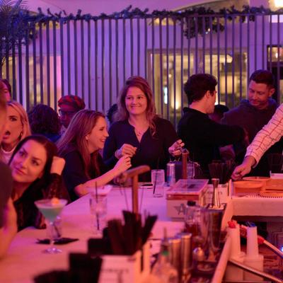 People sitting at bar with warm lighting.