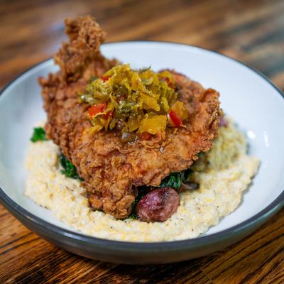 Buttermilk fried chicken breast served with grits and vegetable medley.