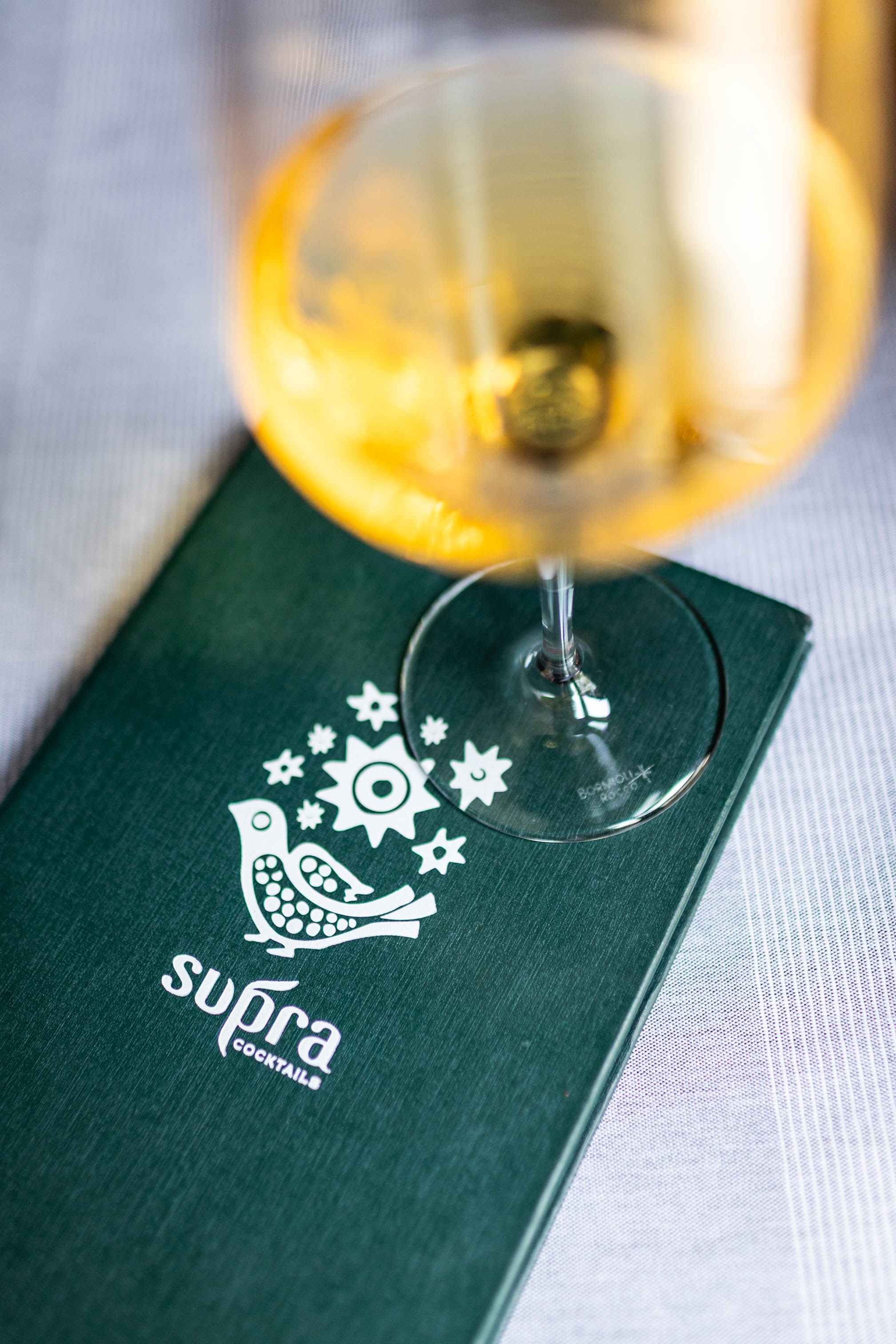 Glass of white wine viewed from above on a green menu