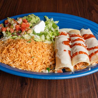 Enchilada Mr Rayo with sides of rice and salad.
