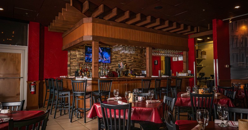 Interior, tables and chairs near bar