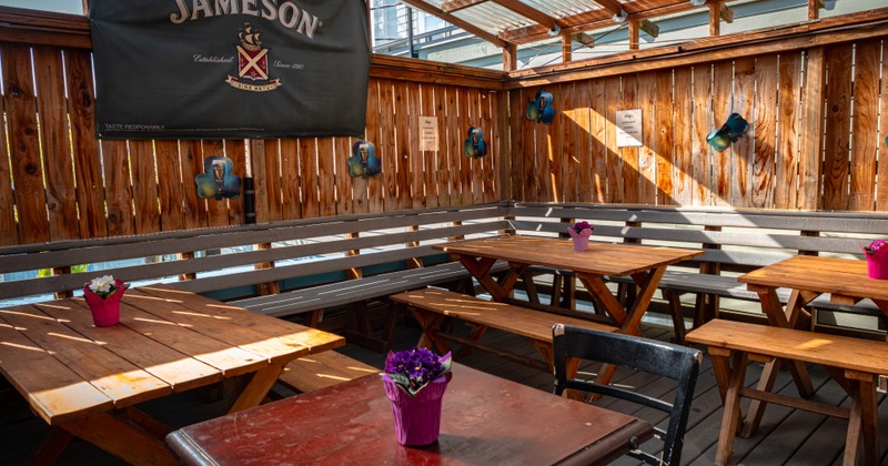 Covered patio, wooden tables with benches