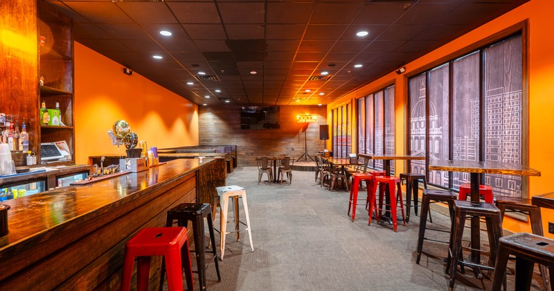 Interior, bar area on the left and tables and stools on the right