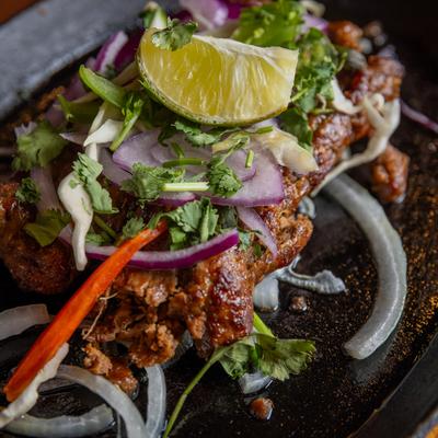 Charcoal grilled skewers of beef, marinated in fresh herbs and spices, with onions, and peppers.