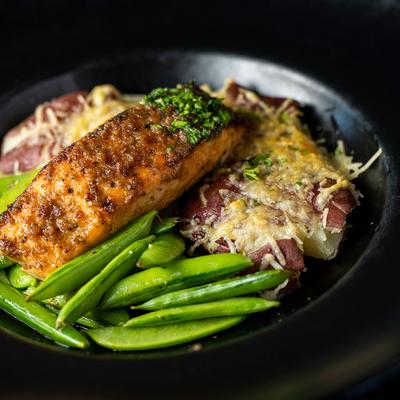 Seared salmon fillet with snap peas and Parmesan red potatoes