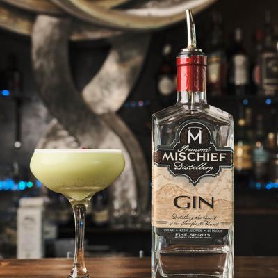 Macha gin sour drink and a bottle of gin on display