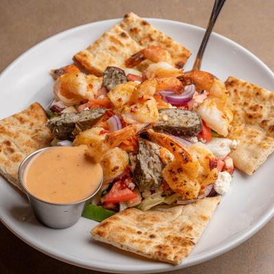 Grilled Shrimp Salad with pita bread and dressing on the side.