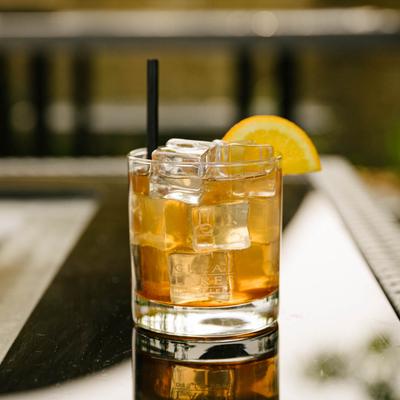Door county sour cocktail, served in a glass, front view.