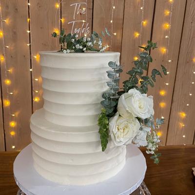 A simple wedding cake decorated with flowers
