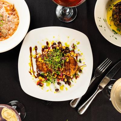 Crab cakes with corn salsa and microgreens.