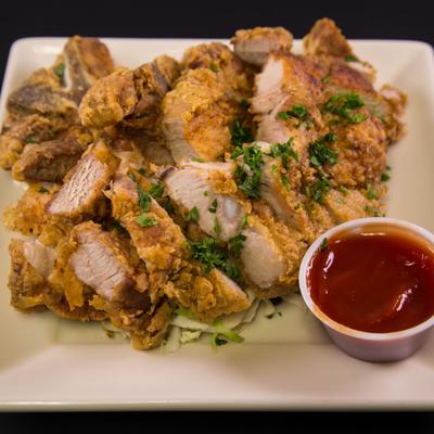 Fried pork chops served with a dip.