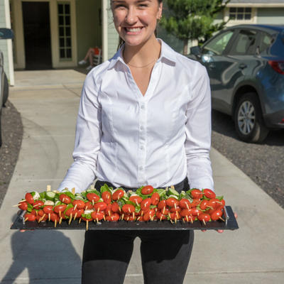 Staff member with plate of grilled vegetables