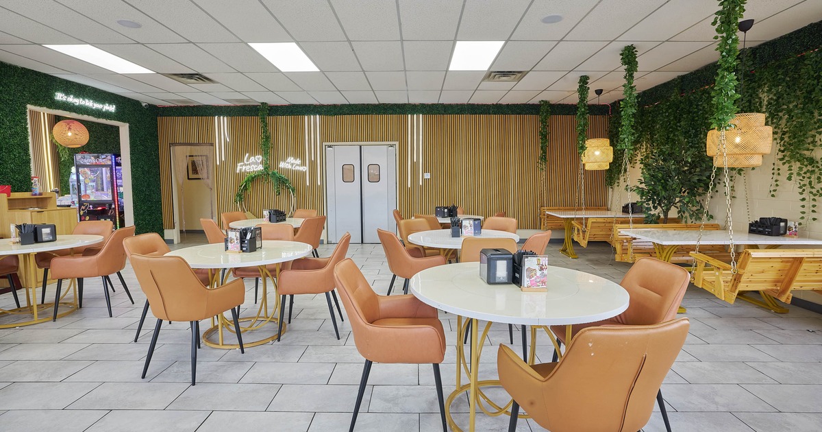 Interior, seating area, round tables for four with leather chairs, tile flooring