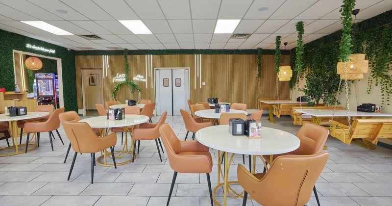 Interior, seating area, round tables for four with leather chairs, tile flooring